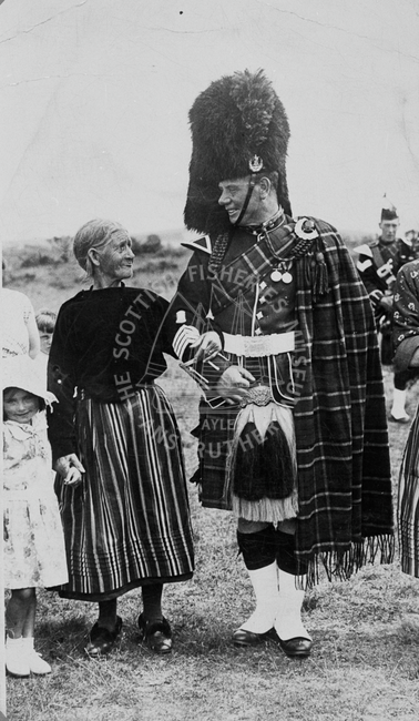 Woman with man in military regalia.