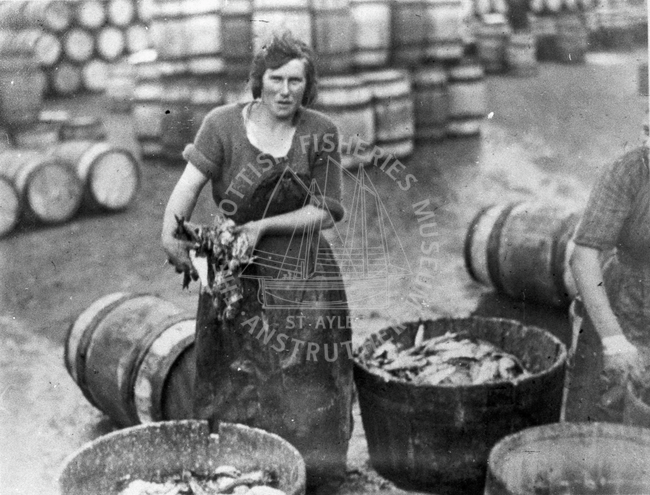 Fisherlass with barrels in the background