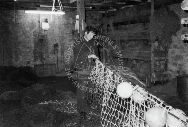 John Williamson mending nets, Whalsay, 1981.