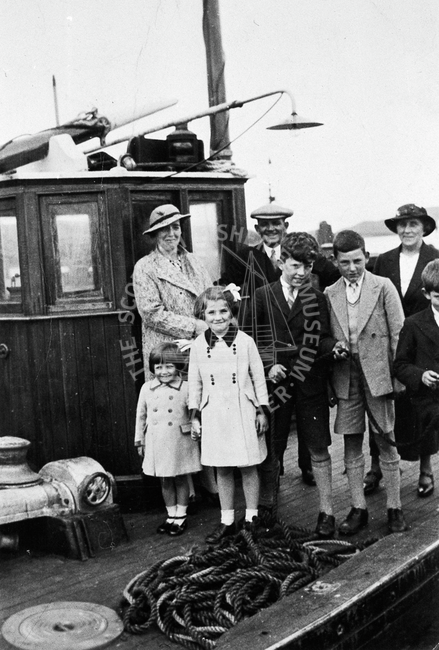 Group portrait of the Meenan family on deck of