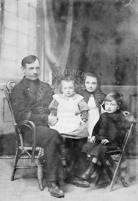 Studio portrait of James Slater and family.