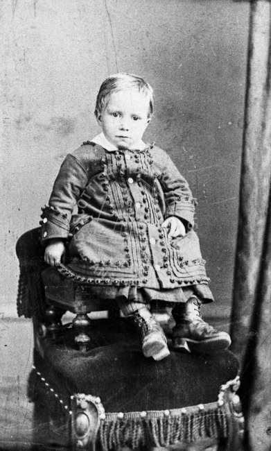 Child on a stool on a chair