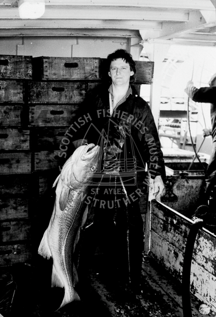 Portait of David Wilson holding catch onboard