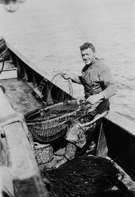 Philip Anderson preparing lines onboard boat.