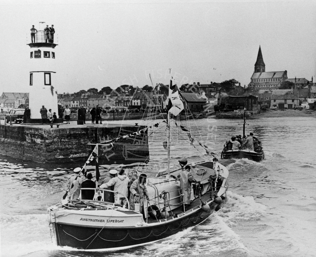 Lifeboat 'The Doctors' entering harbour guided by