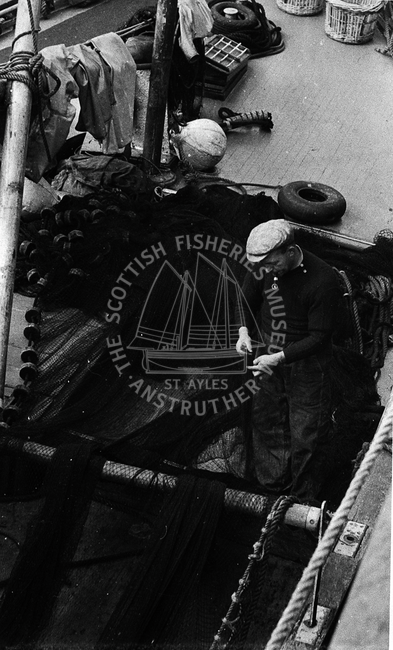 Michael Fairnie repairing a ringnet onboard
