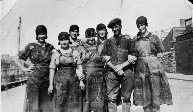 Group portrait of herring girls with a cooper.