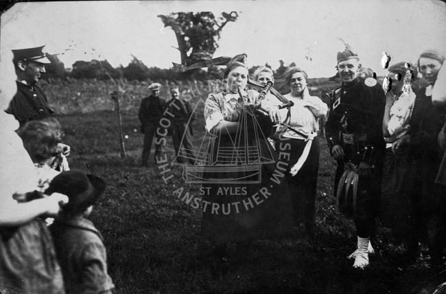 Fishwife with bagpipes, Dunbar, 1920s.