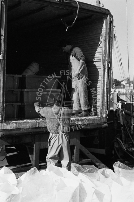 Crew loading boxes of herring into lorry, Tarbert