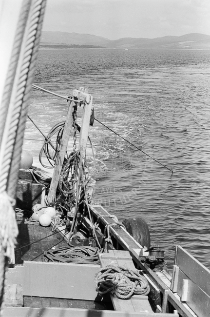 Trawl warps towing net going into water from the