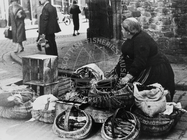 Arbroath fishwife selling produce, Dundee, 1937