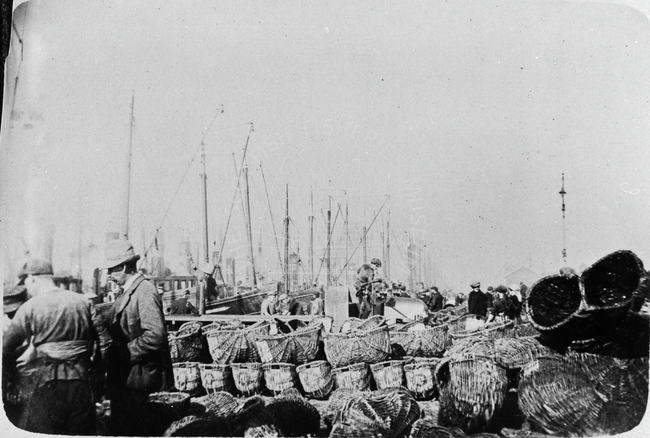 View of Yarmouth quayside with boats and baskets
