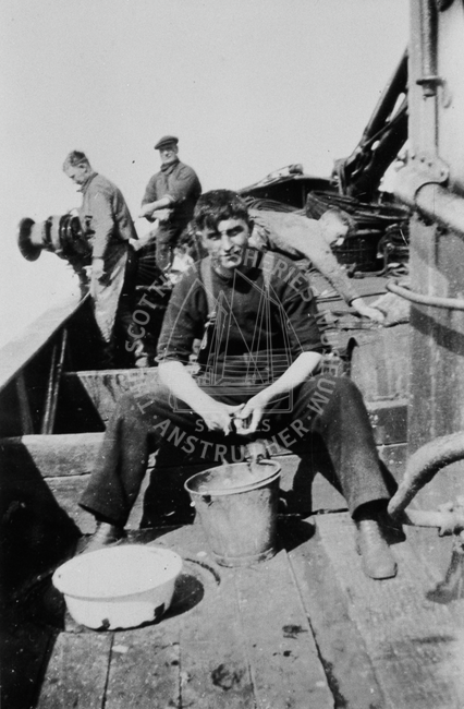 Crew shelling mussels and line fishing on 'Pilot
