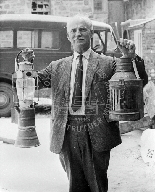 Portrait of Gordon Clarkson holding two lanterns
