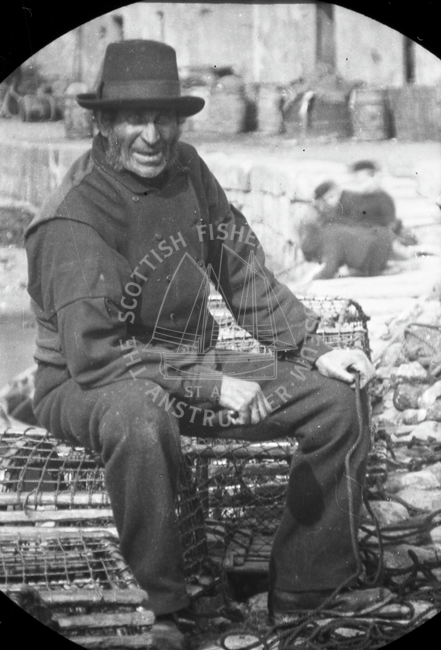 Fisherman Sitting on Lobster Creels by Harbour